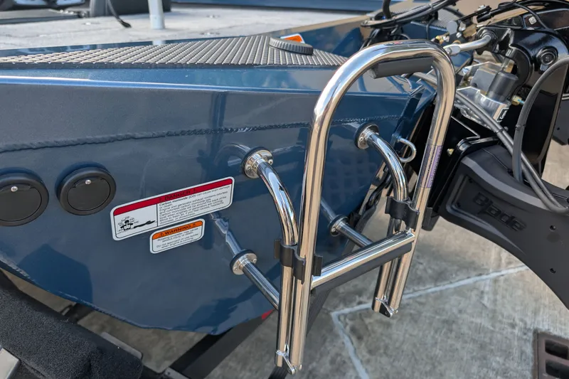 Slide: The Image of 2027 Ranger RT198P boat with stainless steel ladder and warning labels. - 16