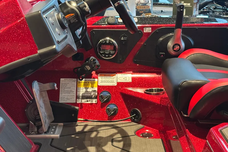 Slide: The Image of Interior of a 2027 Nitro Z21 XL Pro boat with red accents and control panel. - 13