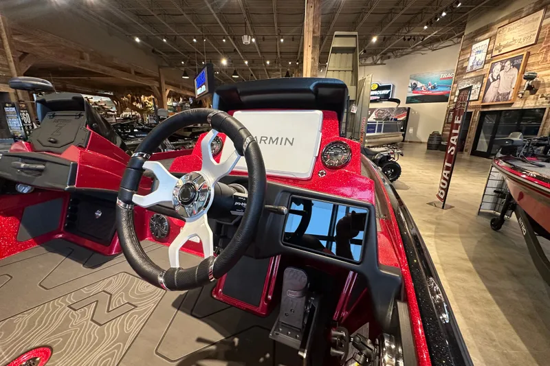 Slide: The Image of 2027 Nitro Z21 XL Pro boat interior with Garmin display and sleek steering wheel. - 11