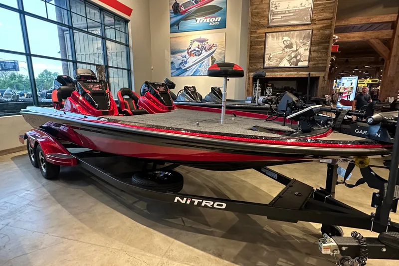 Slide: The Image of 2027 Nitro Z21 XL Pro boat in showroom, featuring sleek red design and advanced equipment. - 2