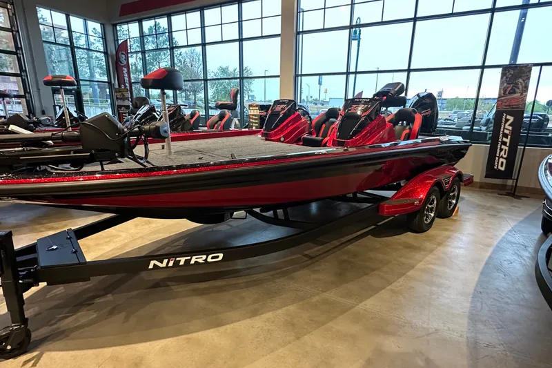 Slide: The Image of 2027 Nitro Z21 XL Pro boat displayed in showroom, featuring sleek red design and modern seating. - 1