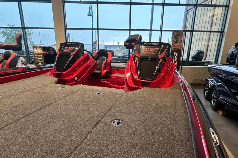Slide: The Image of 2027 Nitro Z21 XL Pro boat interior with red accents in showroom. - 5