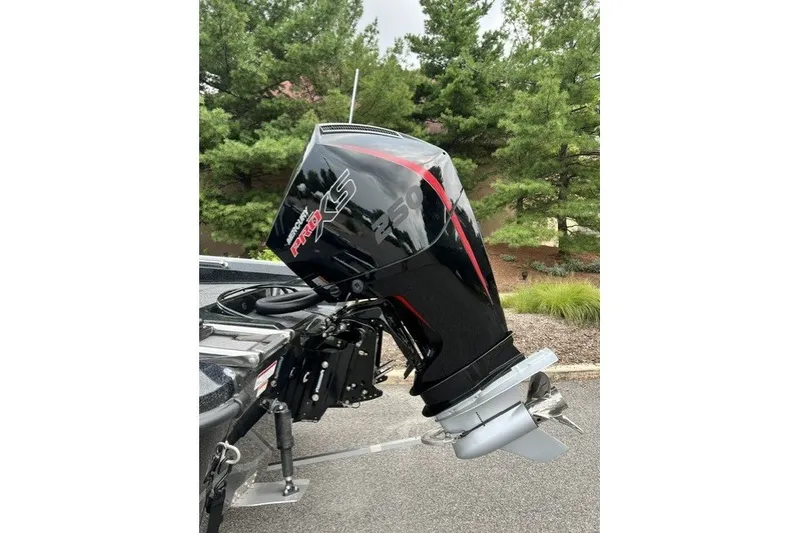 Slide: The Image of Outboard motor on a Nitro ZV20 Pro 2027 boat, parked near lush greenery. - 9
