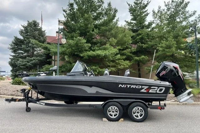 Slide: The Image of 2027 Nitro ZV20 Pro boat on trailer, parked outdoors with trees in background. - 1