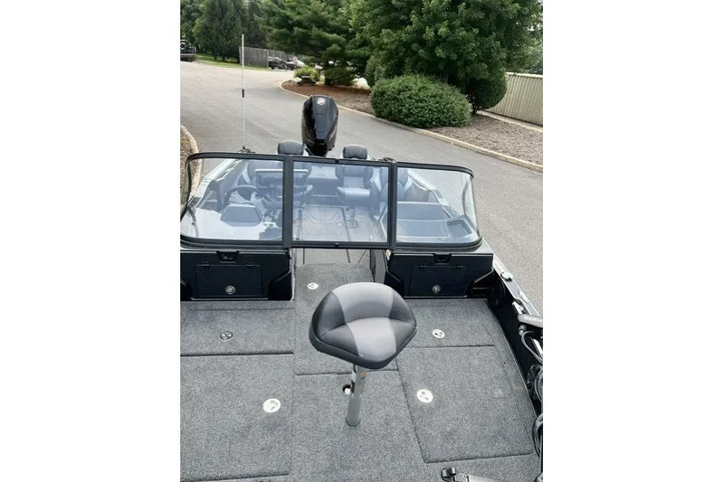 Slide: The Image of 2027 Nitro ZV20 Pro boat with seating and windshield, parked on a road. - 5