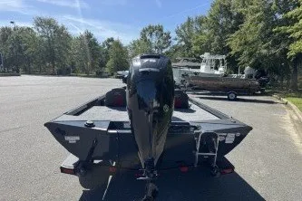 Slide: The Image of 2027 Ranger RT178 boat in parking lot, rear view with outboard motor, surrounded by trees. - 6