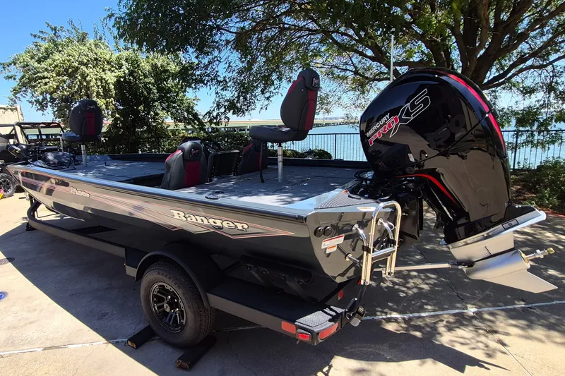 Slide: The Image of 2027 Ranger RT198P boat with Mercury Pro XS engine, parked outdoors near a lake. - 7