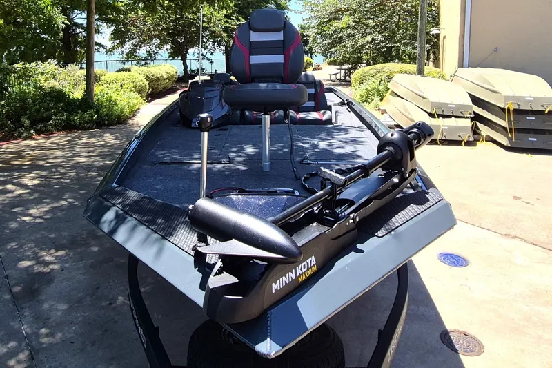 Slide: The Image of 2027 Ranger RT198P boat with Minn Kota trolling motor, parked outdoors. - 2