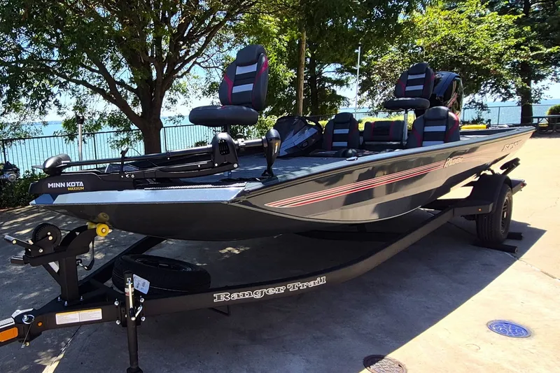 Slide: The Image of 2027 Ranger RT198P fishing boat on trailer, parked near a scenic lakeside. - 1