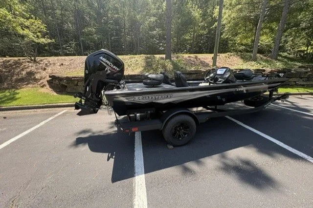 Slide: The Image of 2027 Ranger RT178 boat with Mercury engine parked in a wooded area. - 8