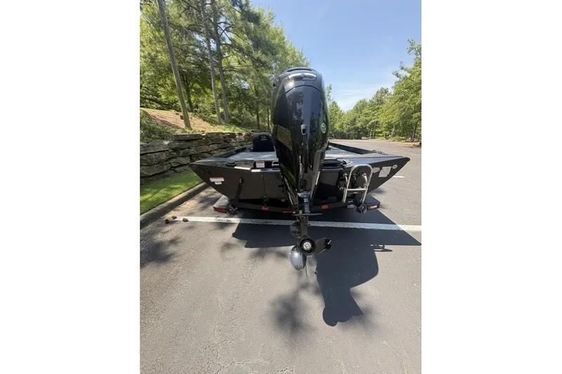 Slide: The Image of 2027 Ranger RT178 boat with outboard motor in a sunny parking lot. - 6