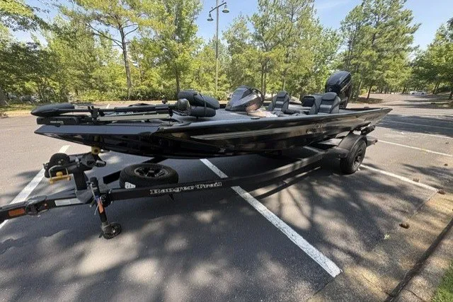 Slide: The Image of 2027 Ranger RT178 boat on trailer in parking lot, surrounded by trees. - 3