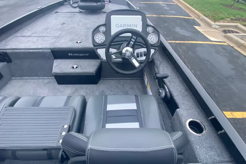 Slide: The Image of 2027 Ranger RT188P boat interior with Garmin dashboard and gray seating. - 8