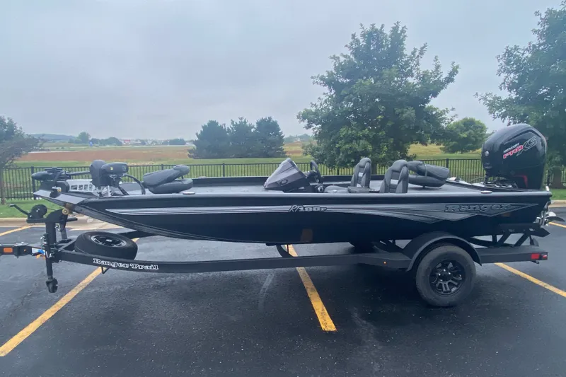 Slide: The Image of 2027 Ranger RT188P fishing boat on trailer in parking lot, overcast day. - 1