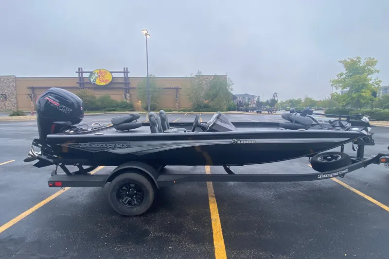 Slide: The Image of 2027 Ranger RT188P boat in parking lot, Bass Pro Shops in background. - 3