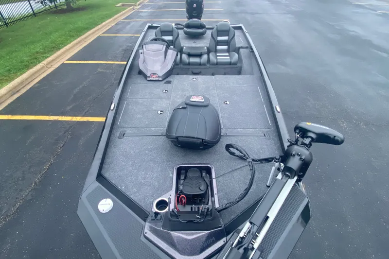 Slide: The Image of 2027 Ranger RT188P fishing boat with spacious deck and modern seating in a parking lot. - 5