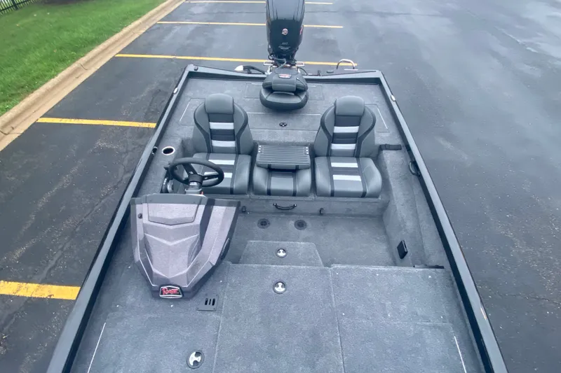 Slide: The Image of 2027 Ranger RT188P boat interior with dual seats and steering wheel, parked on asphalt. - 6