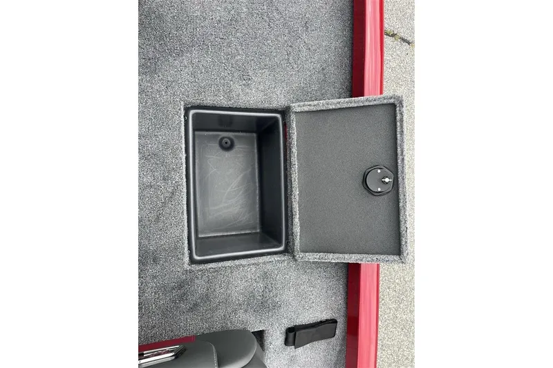 Slide: The Image of Open storage compartment in 2027 Ranger RT178 boat with gray carpeted interior. - 11