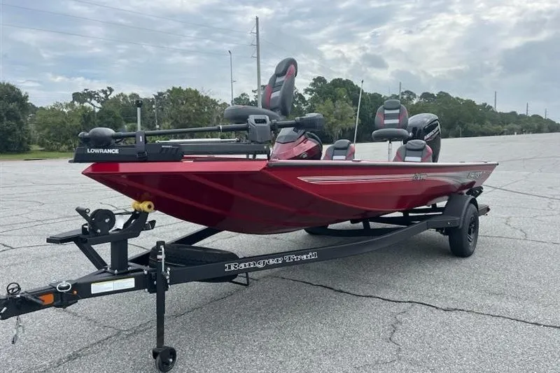 Slide: The Image of 2027 Ranger RT178 fishing boat on trailer, red color, parked outdoors. - 3
