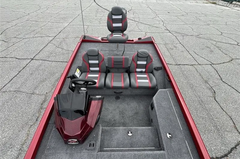 Slide: The Image of 2027 Ranger RT178 boat interior with red and gray seating, steering console, and carpeted flooring. - 6