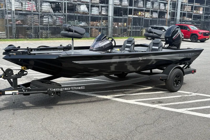 Slide: The Image of 2027 Ranger RT178 boat on trailer in parking lot, featuring sleek black design. - 3