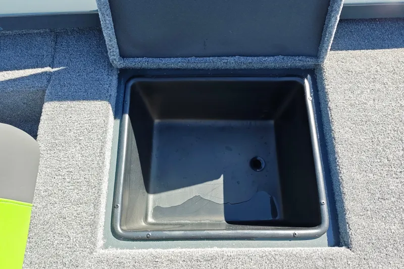 Slide: The Image of Open storage compartment in 2027 Ranger RT198P boat, featuring carpeted interior. - 44
