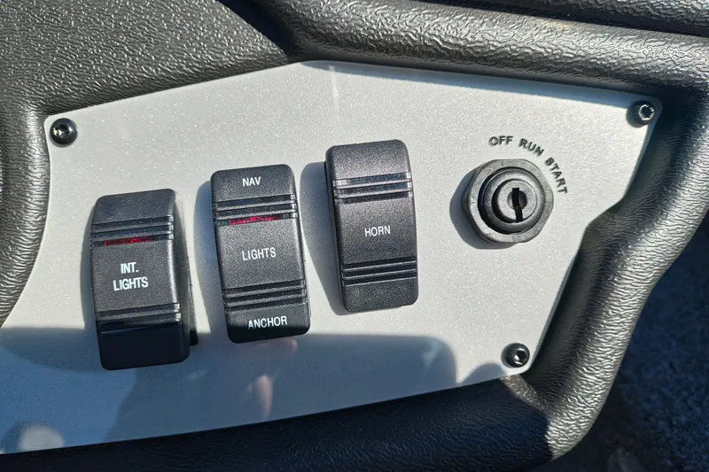 Slide: The Image of Control panel of 2027 Ranger RT198P with switches for lights, horn, and ignition. - 19