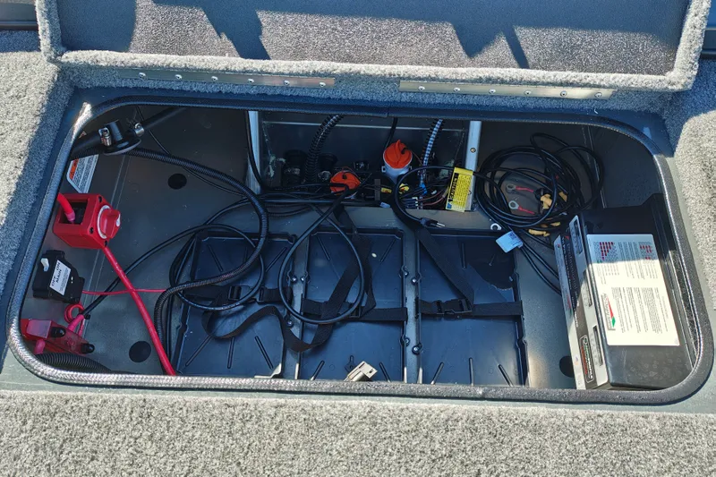 Slide: The Image of Open storage compartment of 2027 Ranger RT198P boat with wiring and battery setup. - 42