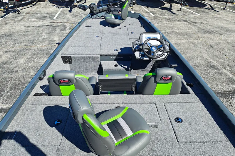 Slide: The Image of 2027 Ranger RT198P fishing boat interior with green-accented seats and steering console. - 12