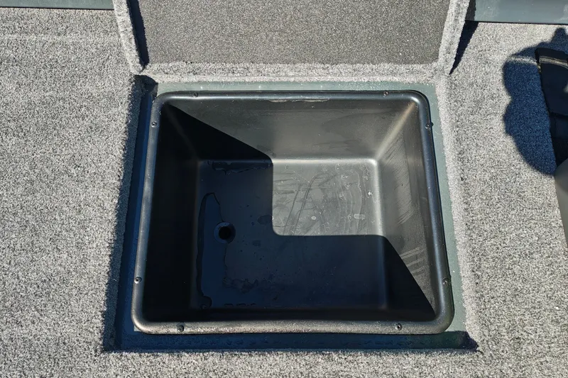 Slide: The Image of Open storage compartment in 2027 Ranger RT198P boat, featuring a carpeted interior. - 43