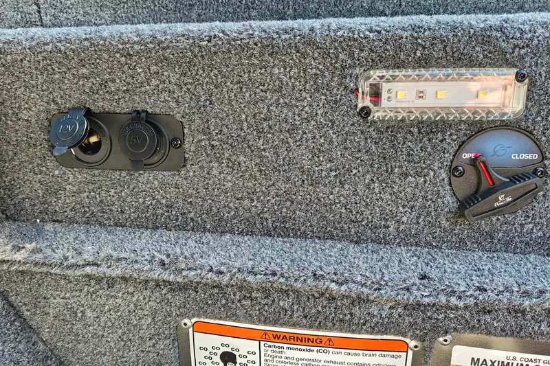 Slide: The Image of Interior of 2027 Ranger RT198P boat showing power outlets and control panel. - 21