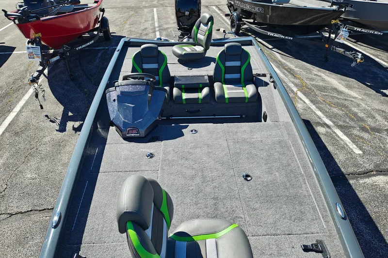 Slide: The Image of 2027 Ranger RT198P fishing boat with green-accented seats in a parking lot display. - 37