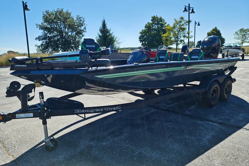 Slide: The Image of 2027 Ranger RT198P boat on trailer, parked outdoors under clear blue sky. - 2