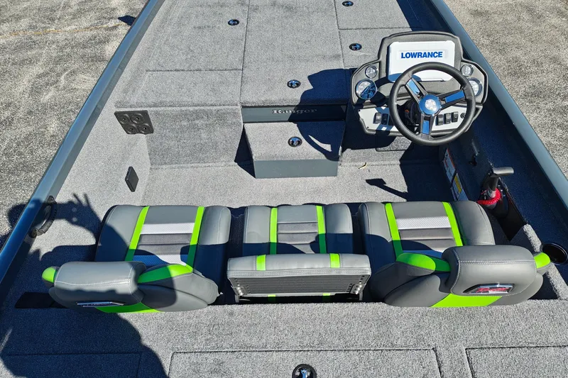 Slide: The Image of 2027 Ranger RT198P boat interior with gray and green seating, steering wheel, and Lowrance electronics. - 13