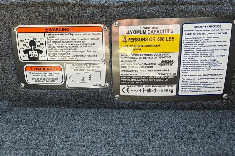 Slide: The Image of Warning labels and capacity information on a 2027 Ranger RT198P boat. - 22