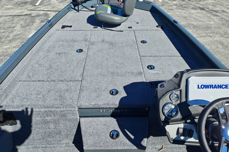 Slide: The Image of 2027 Ranger RT198P boat interior with Lowrance electronics and gray carpeted deck. - 25