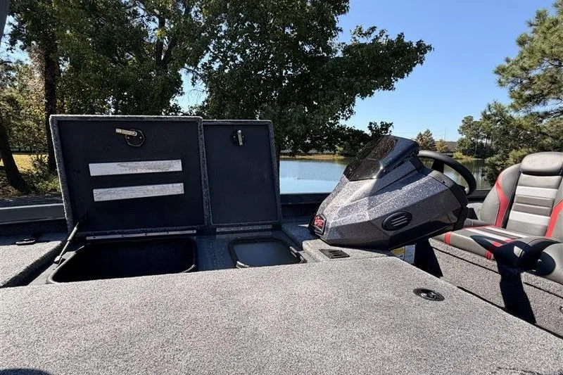 Slide: The Image of 2027 Ranger RT188P boat interior with open storage compartments and steering console. - 17