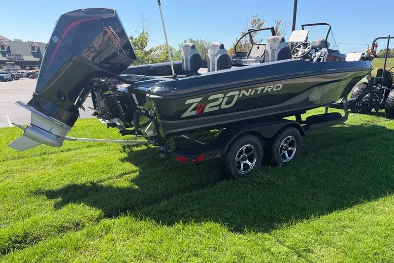 Slide: The Image of 2027 Nitro ZV20 Pro boat on grass, featuring a powerful outboard motor. - 2