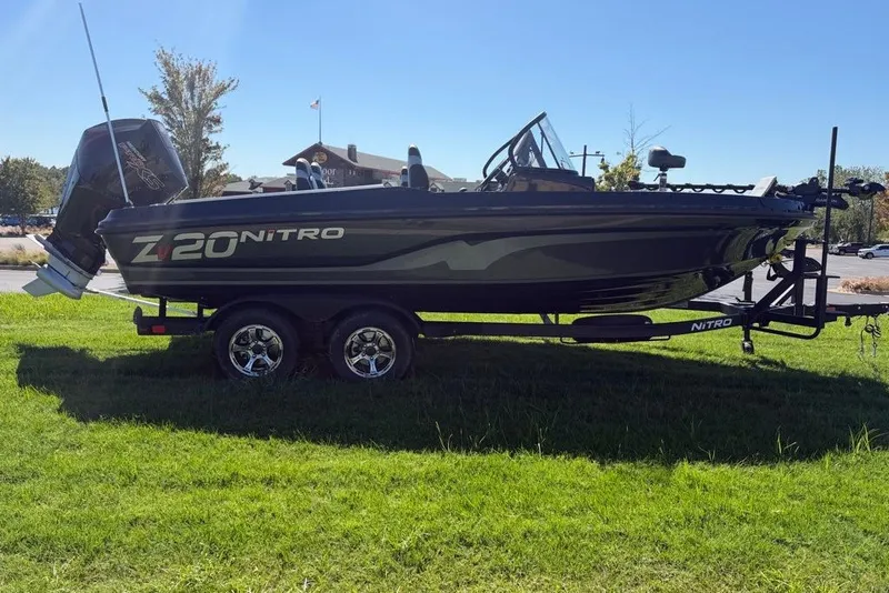 Slide: The Image of 2027 Nitro ZV20 Pro boat on trailer, parked on grass under clear sky. - 3