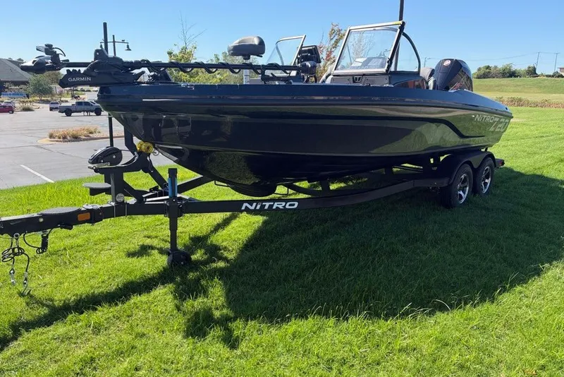 Slide: The Image of 2027 Nitro ZV20 Pro boat on trailer, parked on grass under clear blue sky. - 12