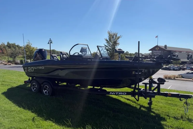 Slide: The Image of 2027 Nitro ZV20 Pro boat on trailer, parked on grass near Outdoor World. - 4