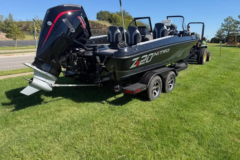 Slide: The Image of 2027 Nitro ZV20 Pro boat on trailer, parked on grass, with powerful outboard motor. - 9