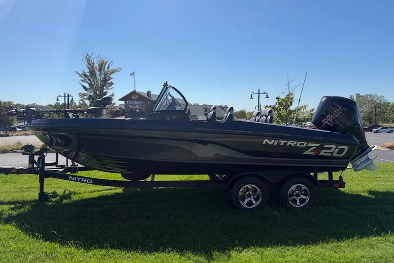 Slide: The Image of Nitro ZV20 Pro 2027 fishing boat on trailer, parked on grass under clear blue sky. - 1