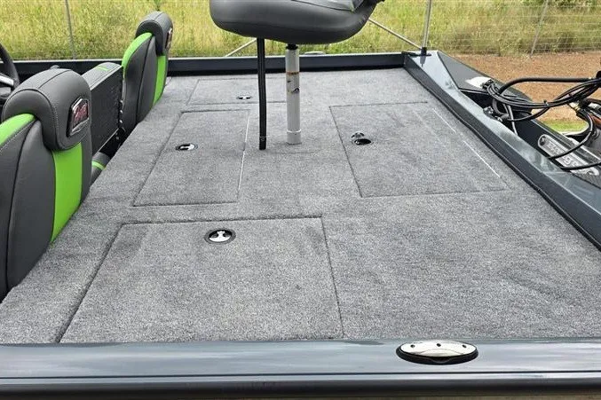 Slide: The Image of 2027 Ranger RT198P boat interior with gray carpet and green-accented seats. - 15