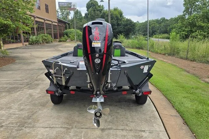 Slide: The Image of 2027 Ranger RT198P boat with 150 HP engine, parked on a driveway. - 4