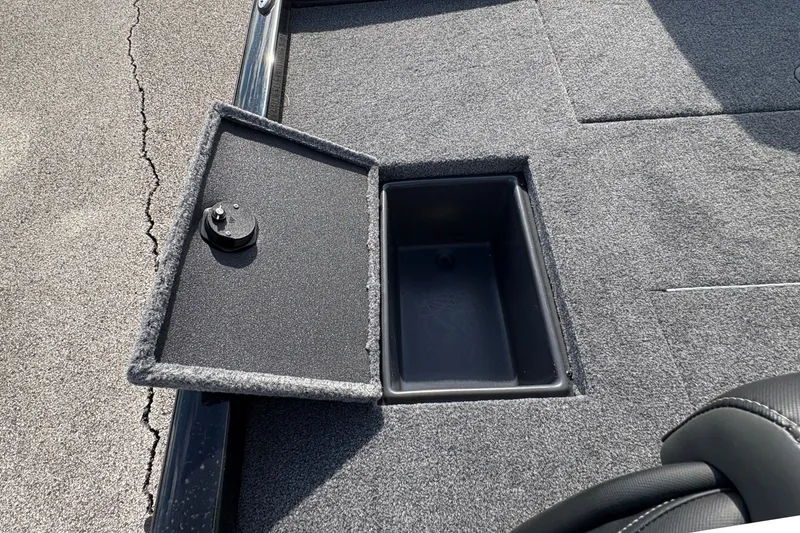 Slide: The Image of Open storage compartment on 2027 Ranger RT178C boat deck, featuring gray carpeting. - 13