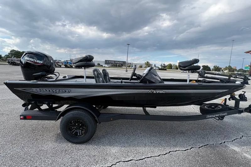 Slide: The Image of 2027 Ranger RT178C fishing boat on trailer, parked in lot under cloudy sky. - 6