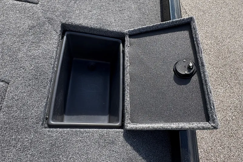 Slide: The Image of Open storage compartment on 2027 Ranger RT178C boat deck, featuring gray carpeting. - 12