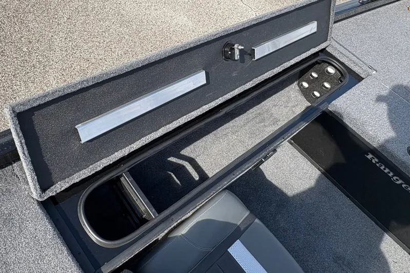 Slide: The Image of 2027 Ranger RT178C boat storage compartment with open lid, showcasing interior design and seating. - 14