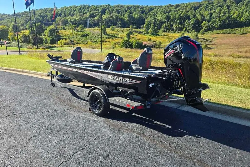 Slide: The Image of 2027 Ranger RT188C boat on trailer, parked on asphalt near scenic green hills. - 3